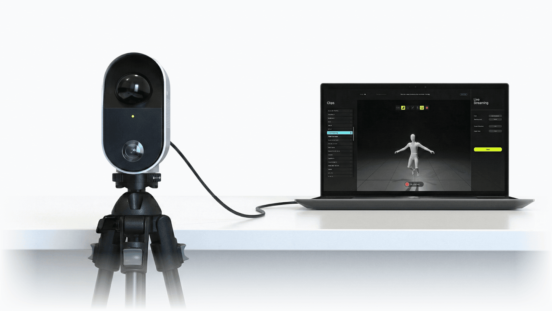MOVIN TRACIN on a tripod connected to a laptop running MOVIN Studio, live streaming a captured figure.